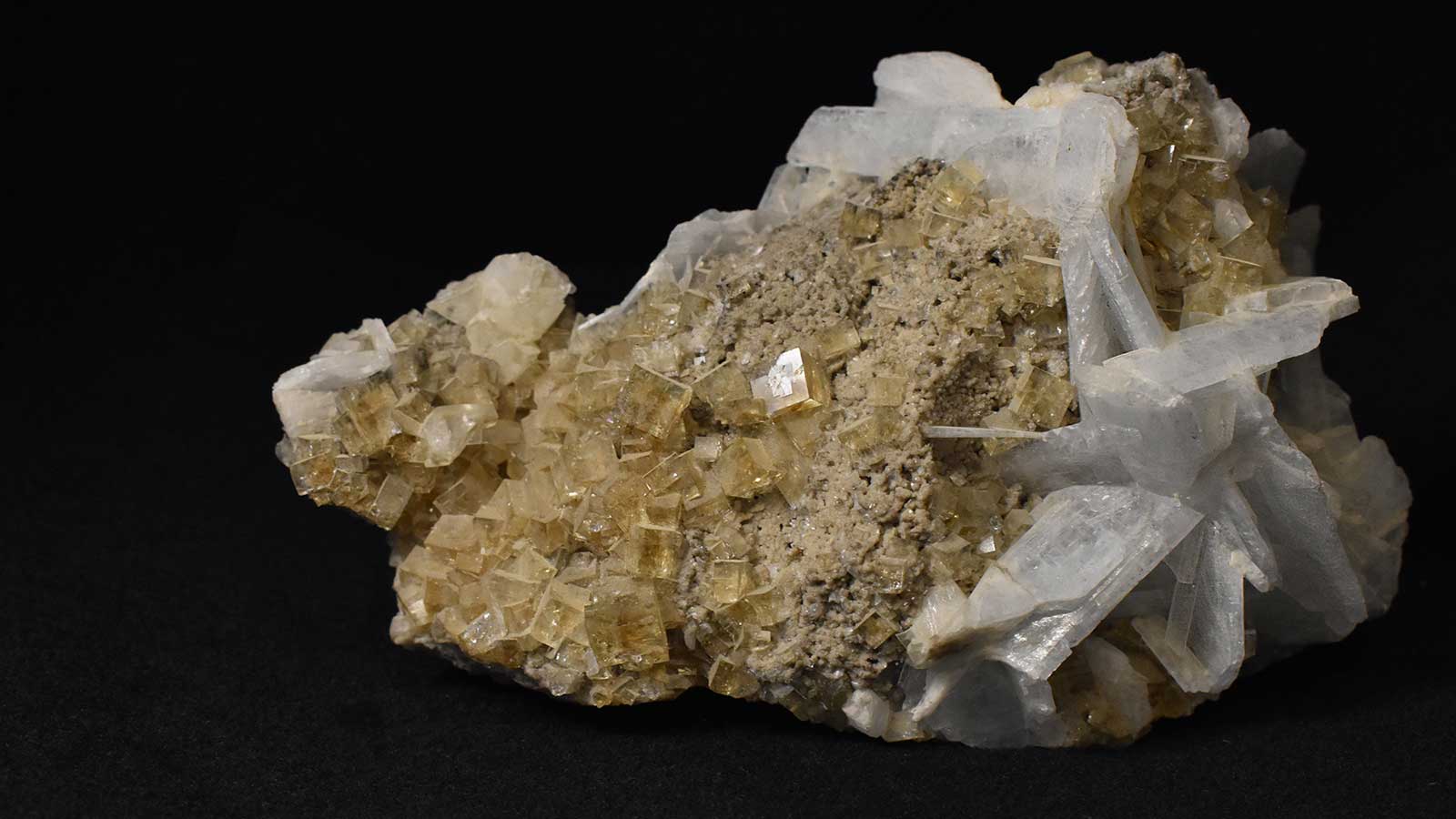 A whitish and tan mineral rock, with jagged and cubed shape crystals