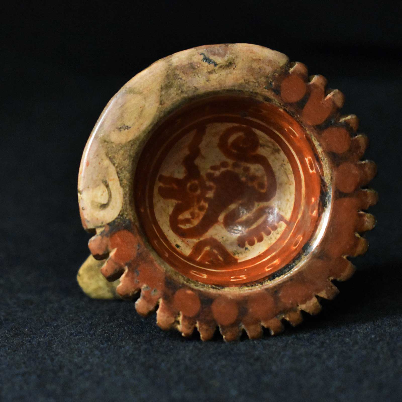 Orange and Tan colored incense burner with painted art depicting an Aztec God