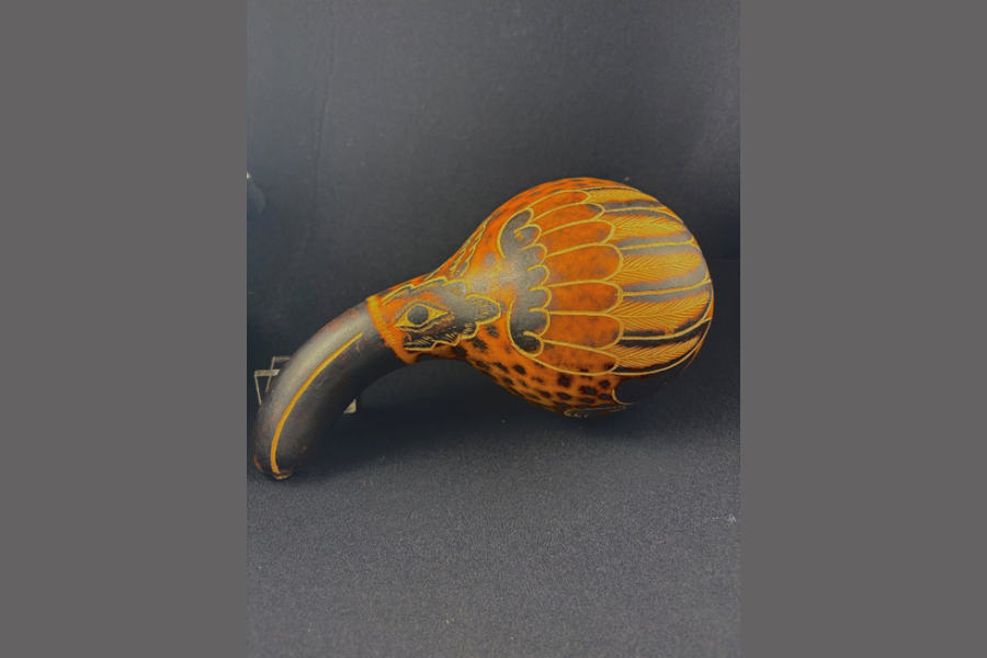 Painted long gourd that is painted in the style of a bird - with the long portion as the beak and the round portion has the body