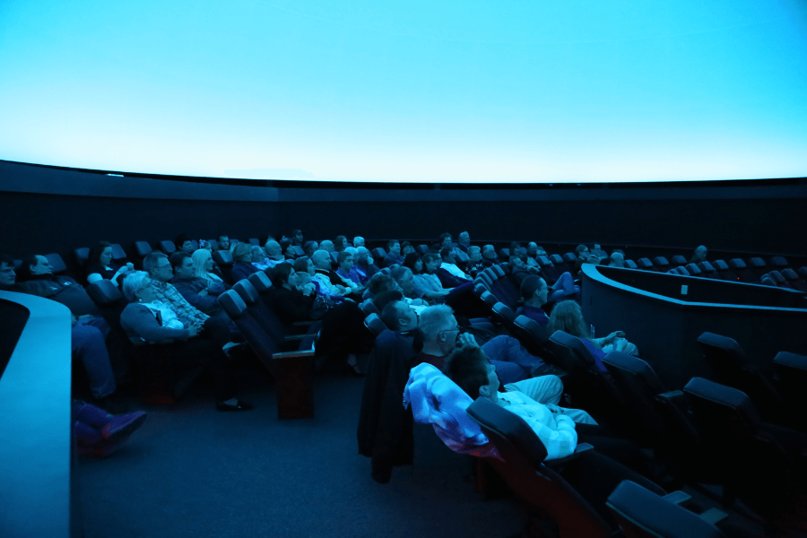 Guests watching a blue screen in the planetarium