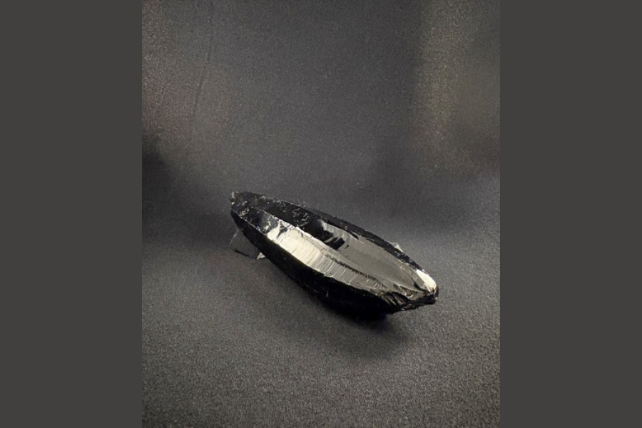 Image of a black worn obsidian rock