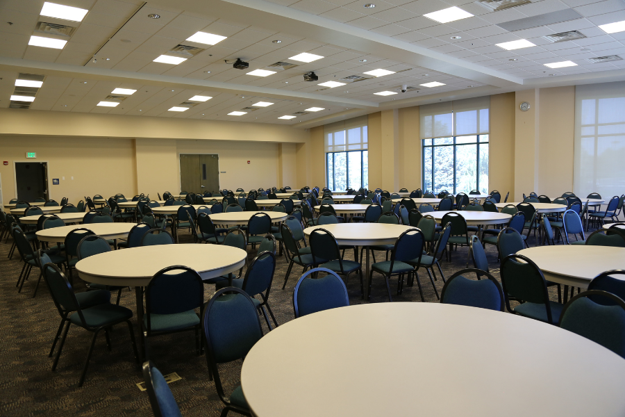 Image of the Rick Allen Room full of round tables with green chairs around them